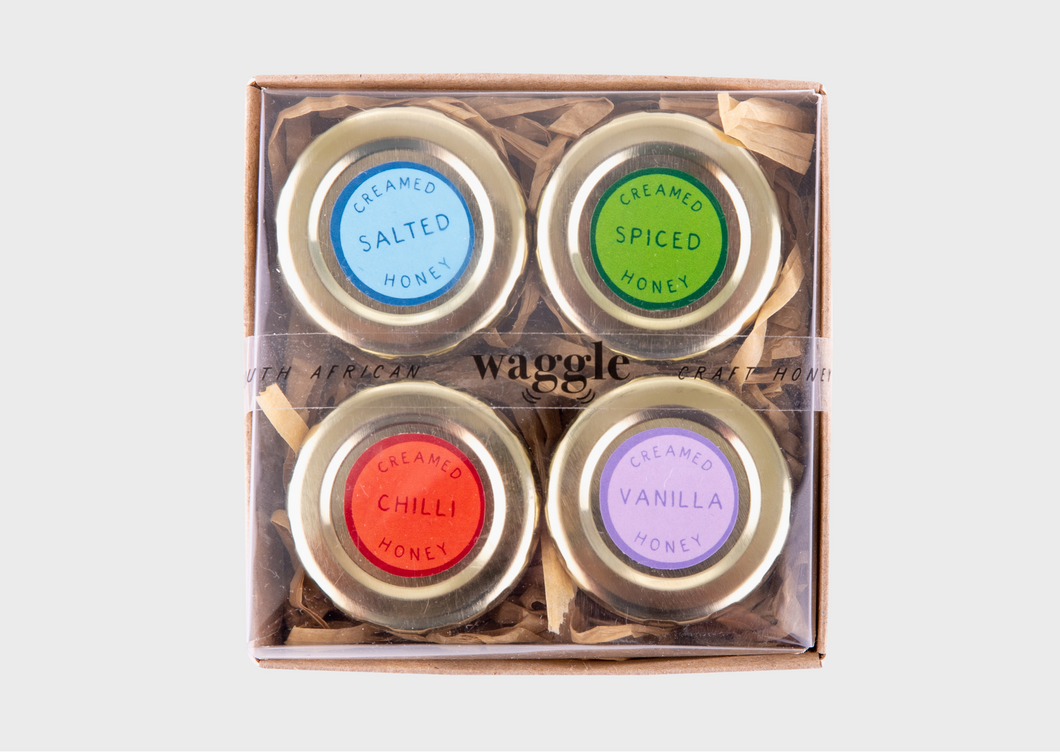 Taster gift set of Waggle Craft Honeys, featuring four mini jars in Salted, Spiced, Vanilla, and Chilli flavours.